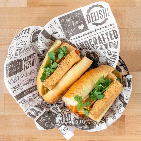 Two Plum Vietnamese Restaurant banh mi sandwiches with tofu and cilantro in a basket.