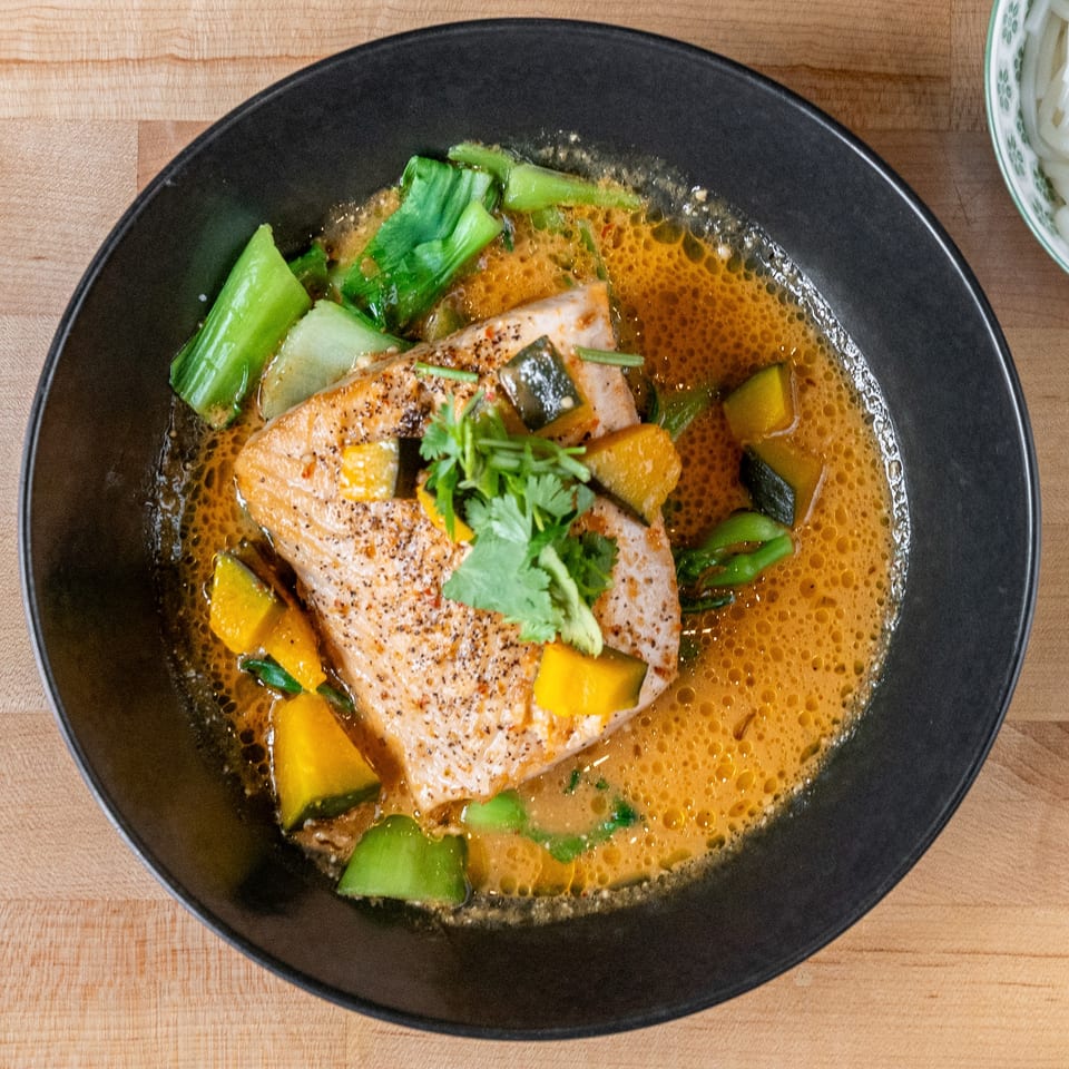 Plum Vietnamese Restaurant's salmon in a rich broth with bok choy, squash, and cilantro.